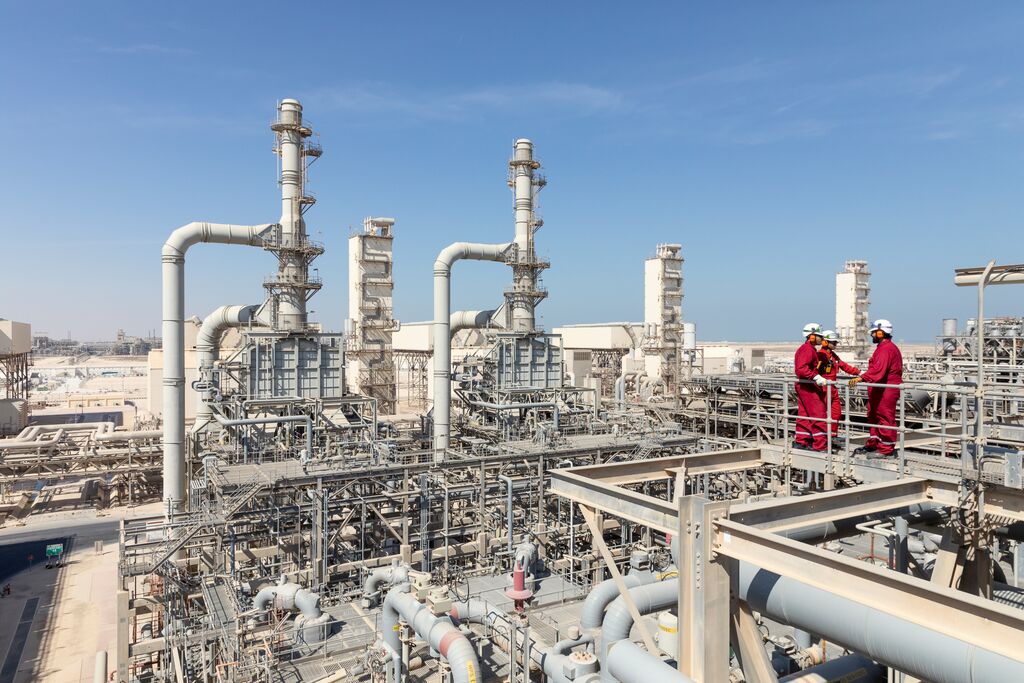 The Pearl gas to liquids plant. A group of operators, standing on the top of a unit. Doha, Qatar. MENA, 2016